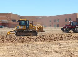 komatsu dozer with ripper beside school